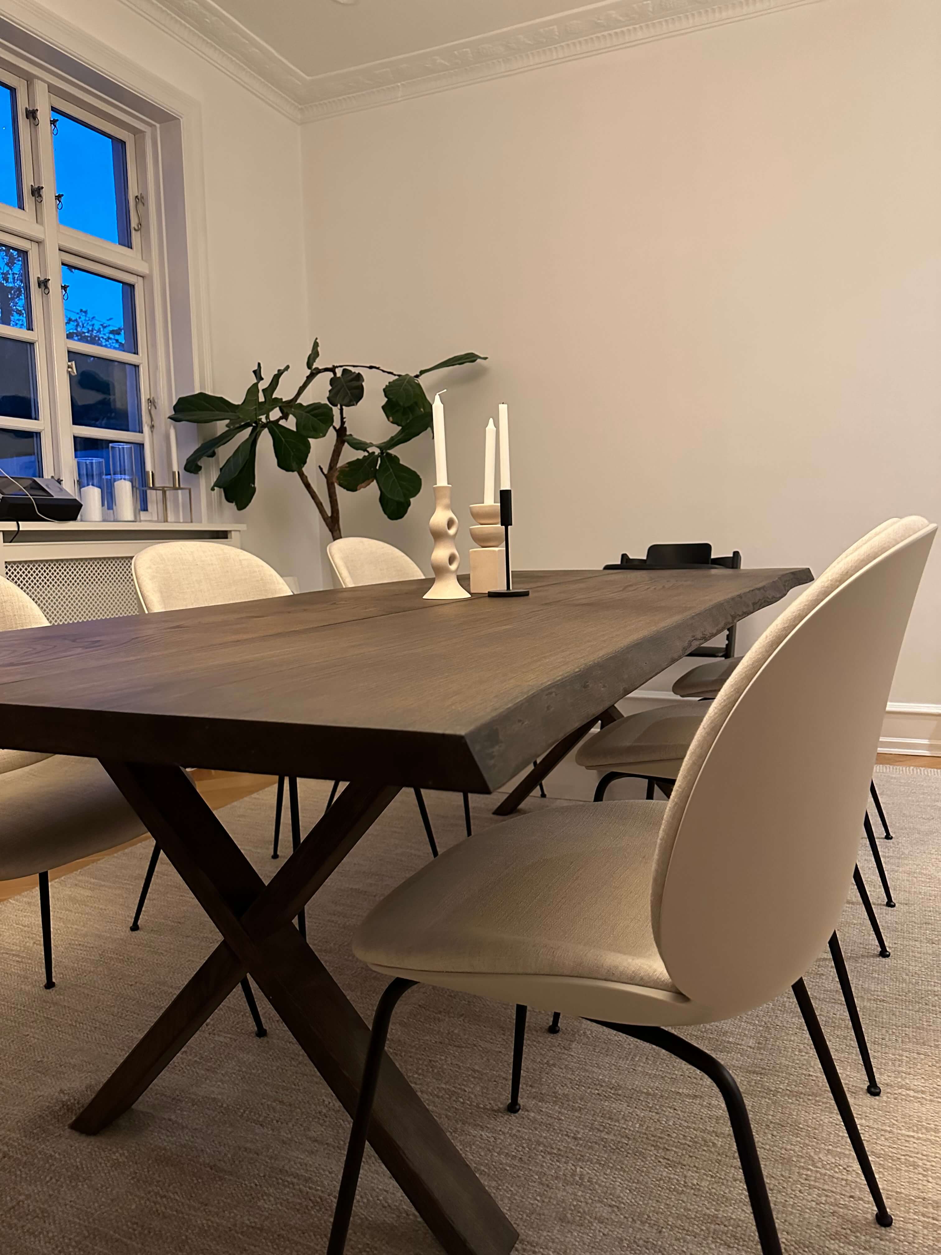 sortolieret plankebord i egetræ med hvide stole rundt om